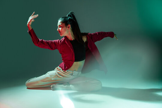 Latin woman dancer performing expressive floor choreography