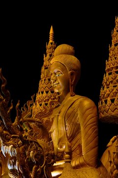 Intricate traditional Thai wax carving on a giant candle for Buddhist Lent Festival