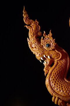 Intricate traditional Thai wax carving on a giant candle for Buddhist Lent Festival