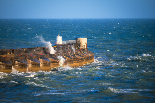 Storm Waves Crashing Against Concrete Breakwater