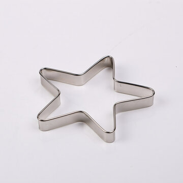 Stainless steel star-shaped cookie cutter on a clean surface, perfect for baking or crafting projects.
