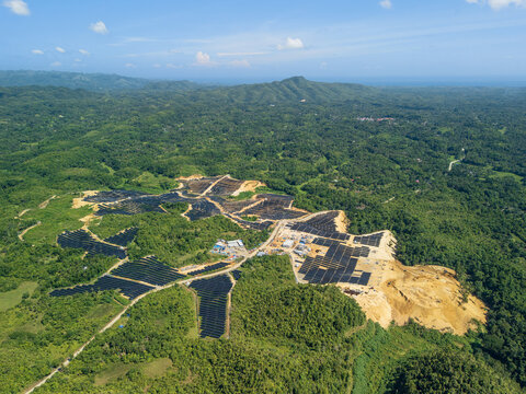 Aerial view of Sikatuna Solar Power Plant featuring rows of solar panels integrated into the hilly, forested landscape of Sikatuna, Central Visayas, Philippines.