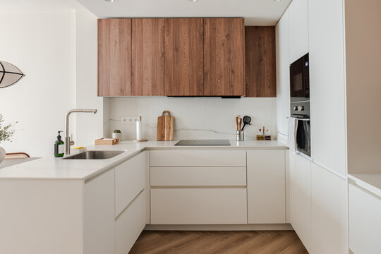 Modern apartment kitchen with wood cabinet and white counter