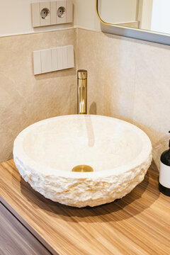 Modern apartment bathroom with stone vessel sink and faucet