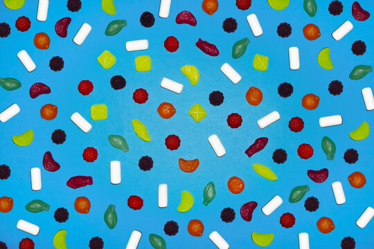 Assorted colorful candy pattern on blue background