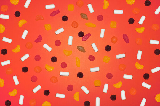 Colorful candy and sugar sweet assortment on red background