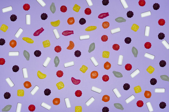 Assorted candy pattern on pastel purple background