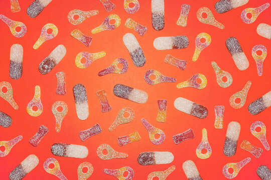 Colorful sugar candy pattern on bright orange background