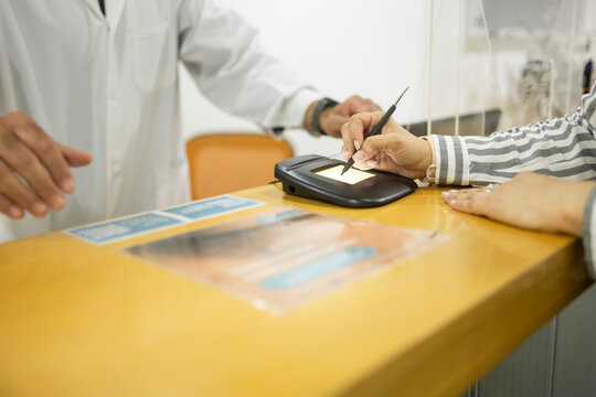 Patient registration at medical clinic reception desk