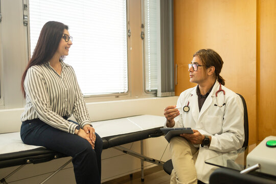 Doctor consult patient in medical clinic examination room