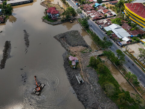 Aerial view of an excavator dredging the river in Banjarmasin, South Kalimantan, Indonesia.
