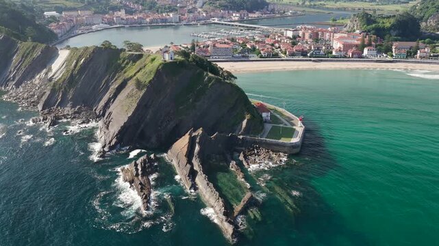 Aerial Panoramic View of Sunrise Over the Coastal Town of Ribadesella, Santa Marina Beach, Sella River Estuary, and Coastal Cliffs in Asturias, Northern Spain