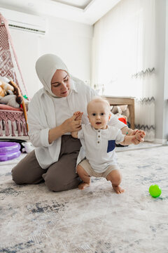 Mother help baby take first step at home