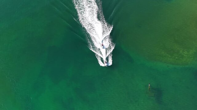 Aerial View of Jet Skiers Navigating the River Mouth and Ocean Waves in Ribadesella, Asturias, Northern Spain