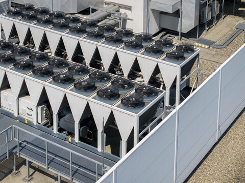 Aerial view of an AI data center cooling system featuring rows of industrial fans and heat exchangers on a rooftop in Krakow, Lesser Poland Voivode, Poland.