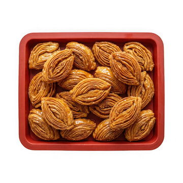 A red tray filled with traditional sweet khaja pastries isolated on transparent background