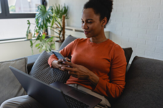 Female freelancer working on a laptop from home. Digital business, entrepreneurship, online collaboration, flexible work schedule and independent professional lifestyle