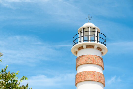 Lighthouse tower against blue sky with copy space, minimal architecture and navigation concept