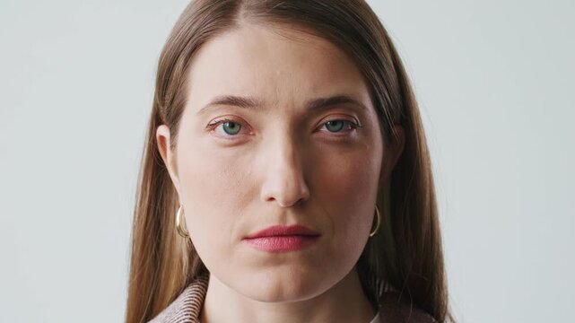 Elegant Caucasian woman looking into camera with confident expression. Detailed portrait female with green eyes showing natural beauty and professional appearance. Studio style close up.