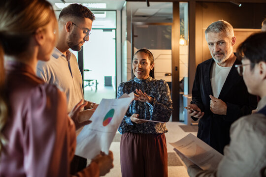 Diverse business team discussing data in modern office