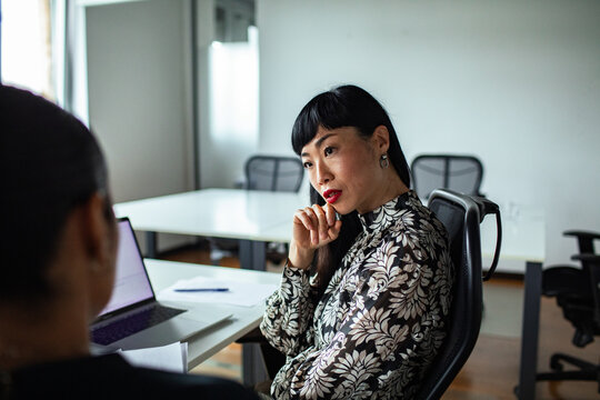 Thoughtful businesswoman listening during office meeting