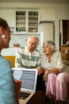 Senior couple consulting advisor at home