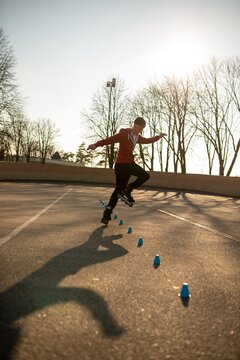 Young man practicing freestyle rollerblading tricks