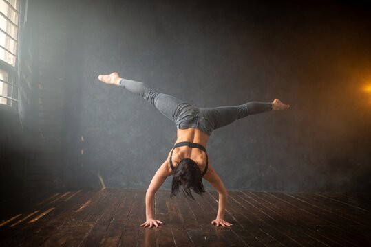 Strong girl executing an upside down handstand split