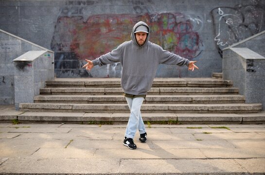 Casual portrait of street dancer sitting on stone staircase