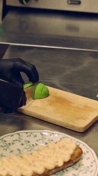 Chef drizzling balsamic glaze over gourmet avocado toast with poached egg
