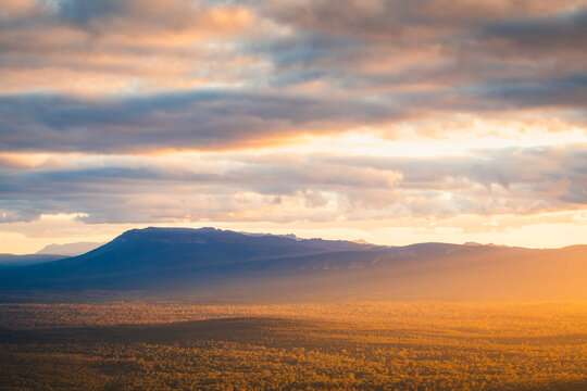 Mountain vista landscape in Grampians National Park, Victoria, Australia, during a bright, dramatic sunset with stormy clouds. 