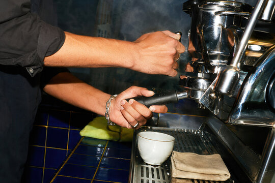 Barista steaming milk with a professional espresso machine