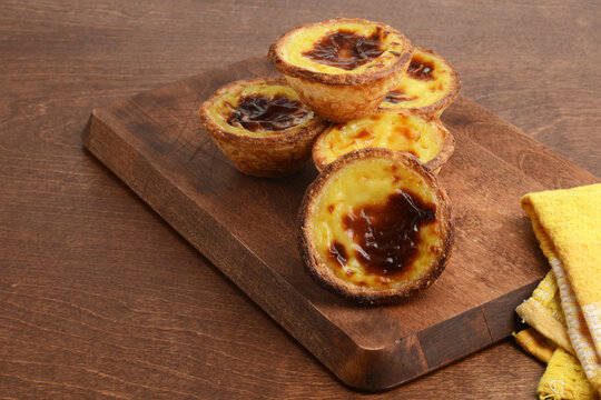 fresh baked Portuguese Custard Tarts Pastel de nata on cutting board