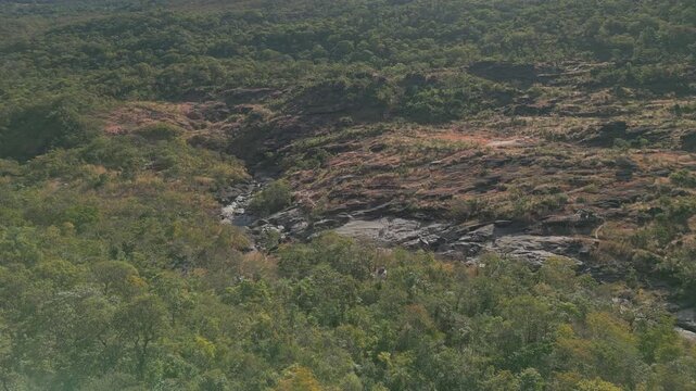 Weathered quartzite bedrock along the Sao Miguel River at Vale da Lua, Chapada dos Veadeiros National Park, Alto Paraiso de Goias, Goias, Brazil, drone parallax.