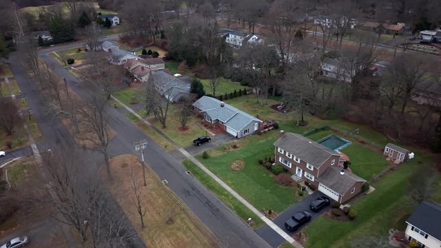 Quiet Residential Street In Stratford, Connecticut, Lined With Middle-class Homes And Leafless Trees In Fall.