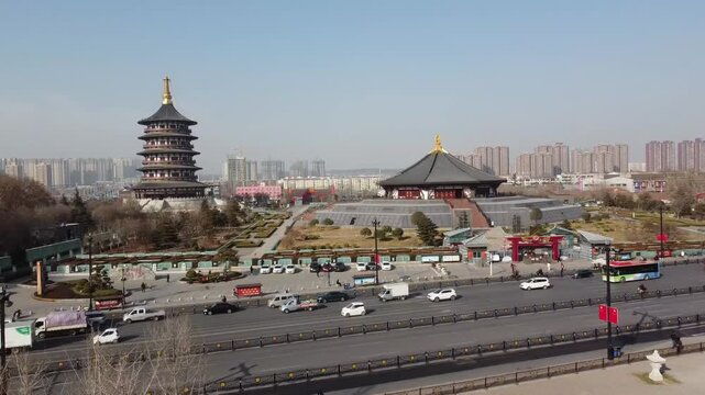 Aerial view of the historic Old Town of Luoyang featuring a traditional pagoda and temple complex surrounded by urban roads and buildings in Luoyang City, Henan, China.