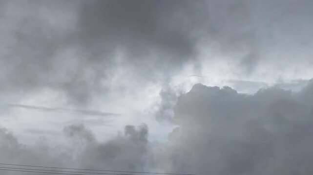 An overcast sky with dark gray clouds indicating extreme rain or a storm with severe weather.