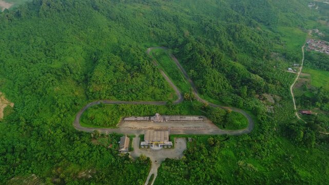 Aerial view of Kalan Circuit surrounded by lush green hills and dense forest in Samarinda, East Kalimantan, Indonesia.