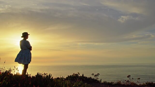 Silhouette of Woman Watching Sunset Over Atlantic Ocean