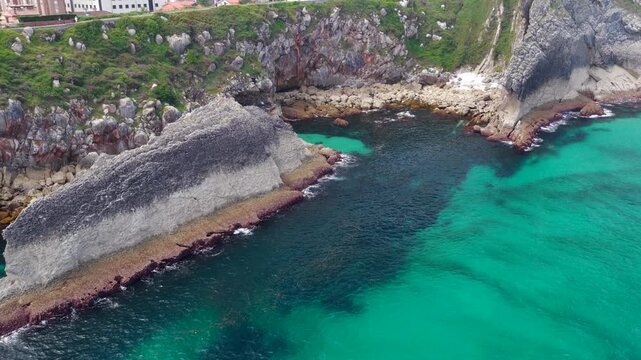 Aerial View of the Sea Cliffs and Green Grass Footpath Along Paseo de San Pedro Hiking Trail in Llanes, Asturias, Northern Spain