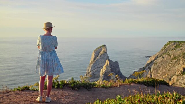 Woman Standing at Scenic Coastal Viewpoint in Portugal