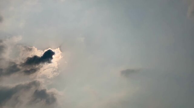 4K timelapse footage showing the sun becoming obscured by dark clouds before emerging and shining again above Jakarta, Indonesia. A dynamic weather sequence suitable for climate, nature, environmental