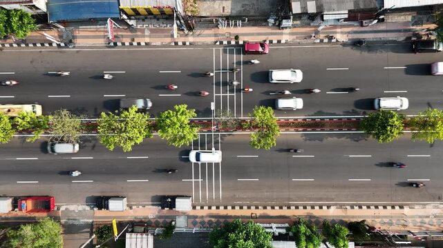 Aerial view of road near the Adipura Monument with traffic flowing on the road during a busy moment in Semarang, Central Java, Indonesia.