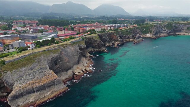 Aerial View of the Sea Cliffs and Green Grass Footpath Along Paseo de San Pedro Hiking Trail in Llanes, Asturias, Northern Spain