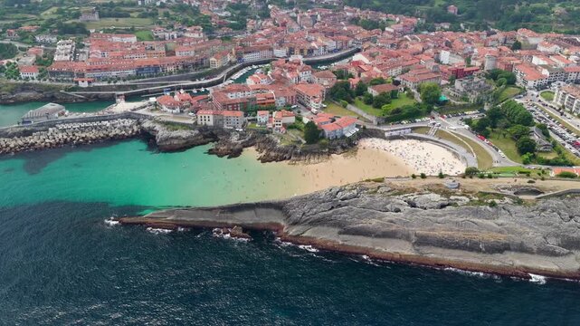 Aerial View of the Golden Sand Beach, Turquoise Ocean Water, and Sea Cliffs at Playa del Sabl&oacute;n Below Paseo de San Pedro in Llanes, Asturias, Northern Spain