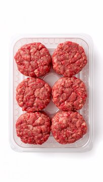 Raw beef burger patties arranged in a plastic tray on a clean white background, showcasing fresh ground beef ready for grilling or cooking.