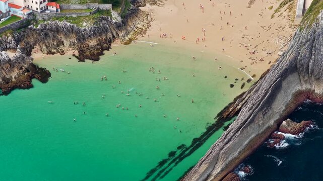 Aerial View of the Golden Sand Beach, Turquoise Ocean Water, and Sea Cliffs at Playa del Sabl&oacute;n Below Paseo de San Pedro in Llanes, Asturias, Northern Spain