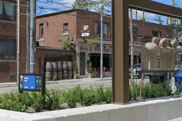 Fototapeta premium wide view of sign at Gallery Park at 129 McCaul St, Toronto (with defocused view of Sin & Redemption, a pub)