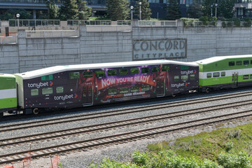 Fototapeta premium TonyBet wrap ad on a GO Train passenger wagon near Concord Cityplace, Union Station Rail Corridor, Toronto