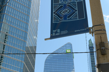 Fototapeta premium looking south (& up) on Simcoe St to Financial District Toronto BIA banner and TD Terrace near King St W